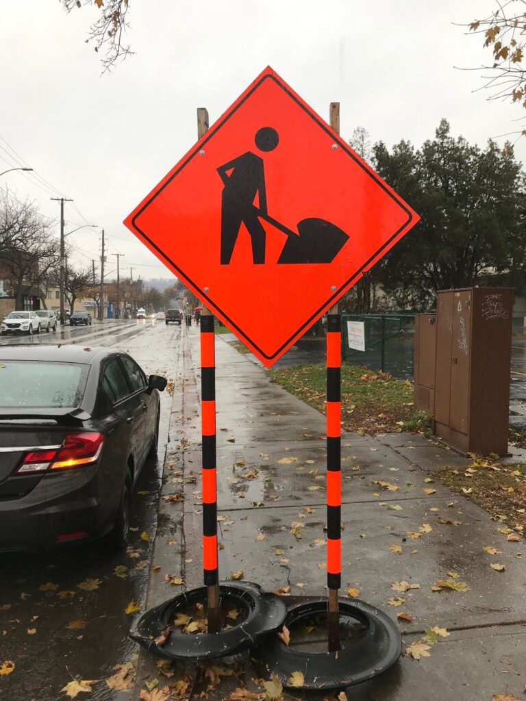 Orange sign with arrow pointing with high visibility STYX.
